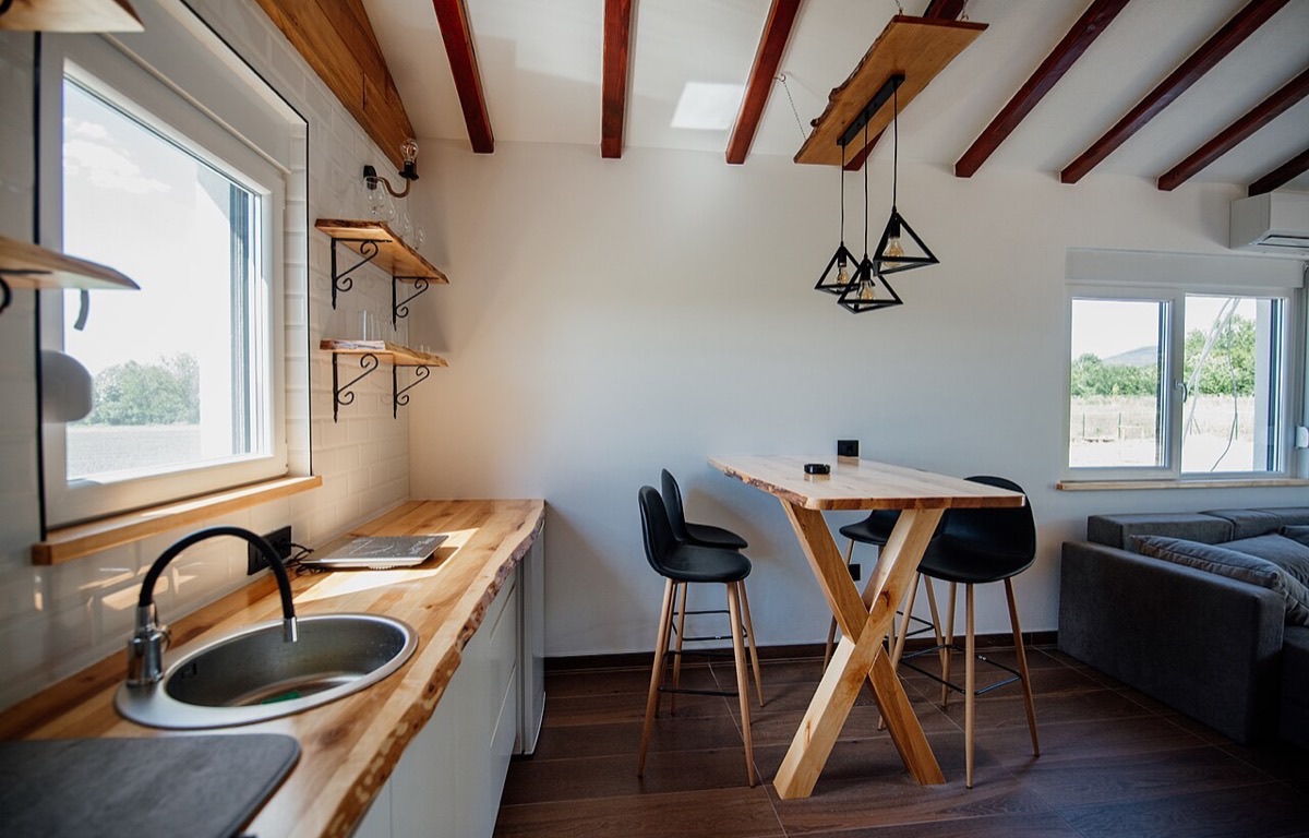 Wood countertop and shelves in a bright modern kitchen