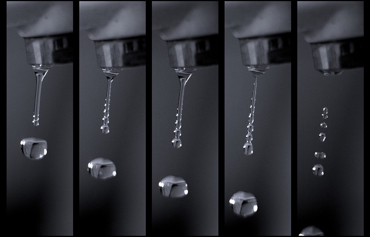 Water droplets falling from a kitchen faucet