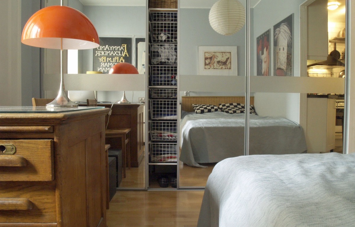 Bedroom wardrobe storage behind mirrored sliding doors
