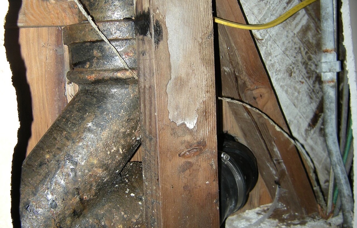 Cast-iron plumbing pipes fixed beneath a basement ceiling