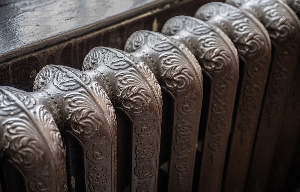 Cast-iron radiator inside a light-filled room
