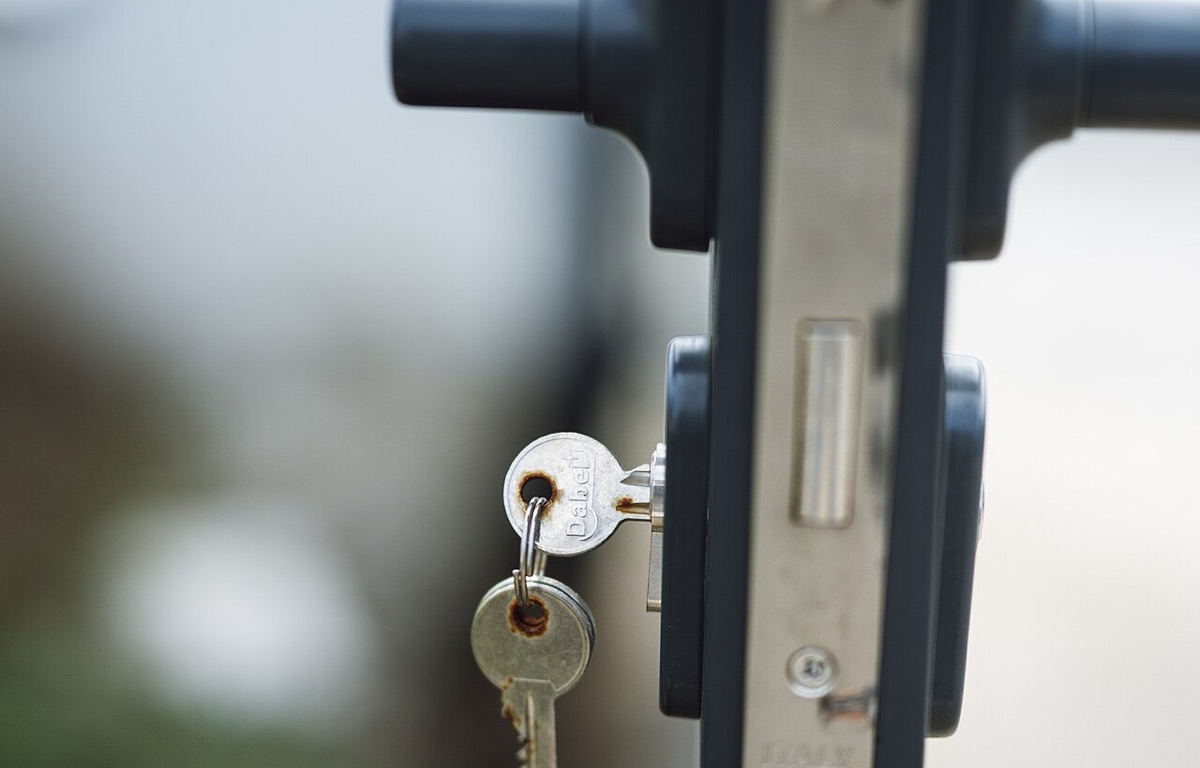 Key hanging from an exterior door lock